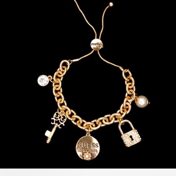 Gold Guess bracelet with pearl and lock charms - Picture 1 of 3